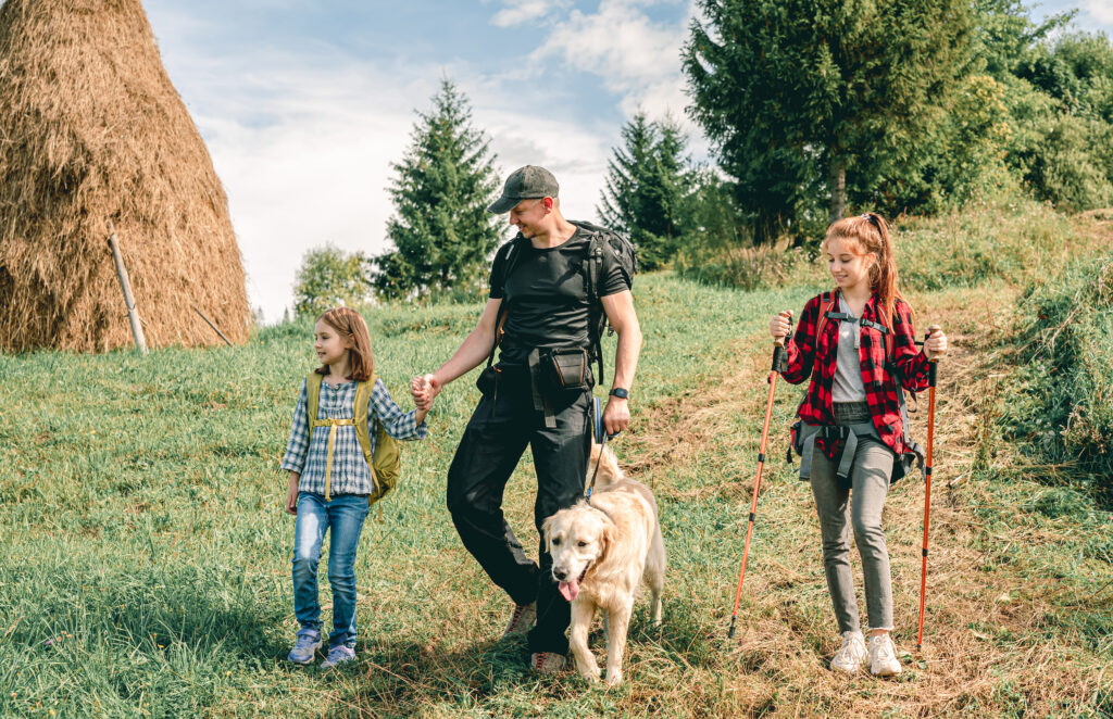 family-hiking-with-their-dog-yellowstone-national-park